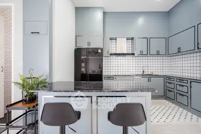 Modern kitchen with sleek cabinetry and island seating in a stylish home.