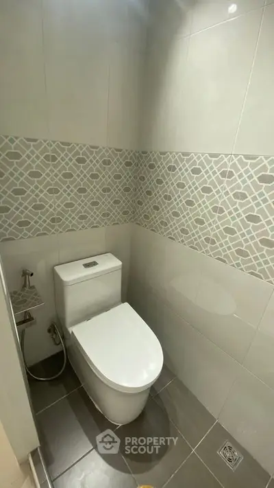 Modern bathroom with stylish tile design and sleek toilet