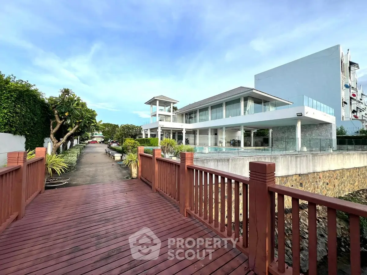 Luxurious waterfront property with modern architecture and spacious outdoor deck.