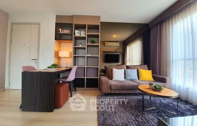 Modern living room with stylish decor and cozy seating area, perfect for relaxation.