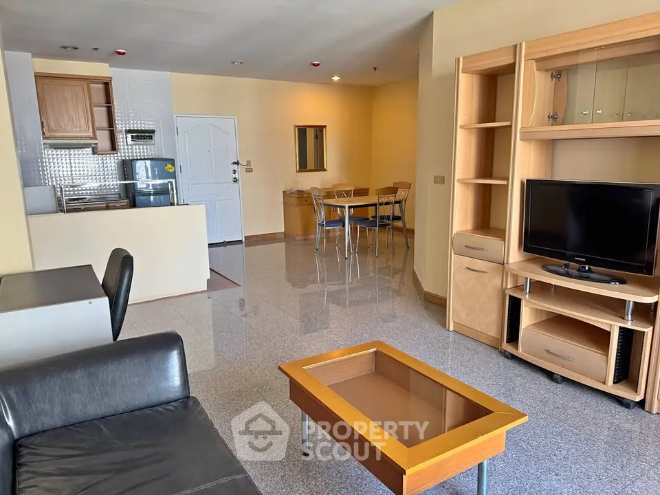 Spacious living room with modern furniture and open kitchen layout in a stylish apartment.