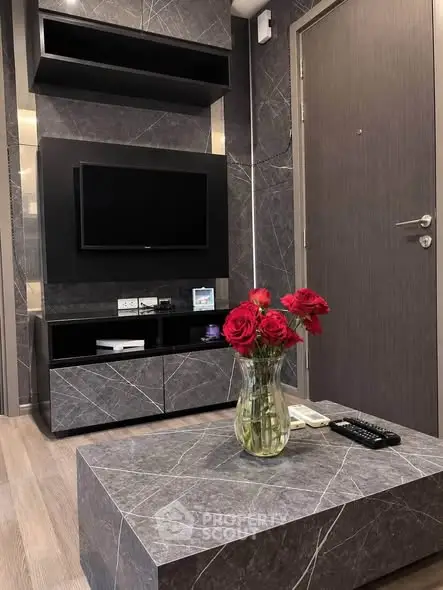 Modern living room with sleek TV setup and elegant marble coffee table.