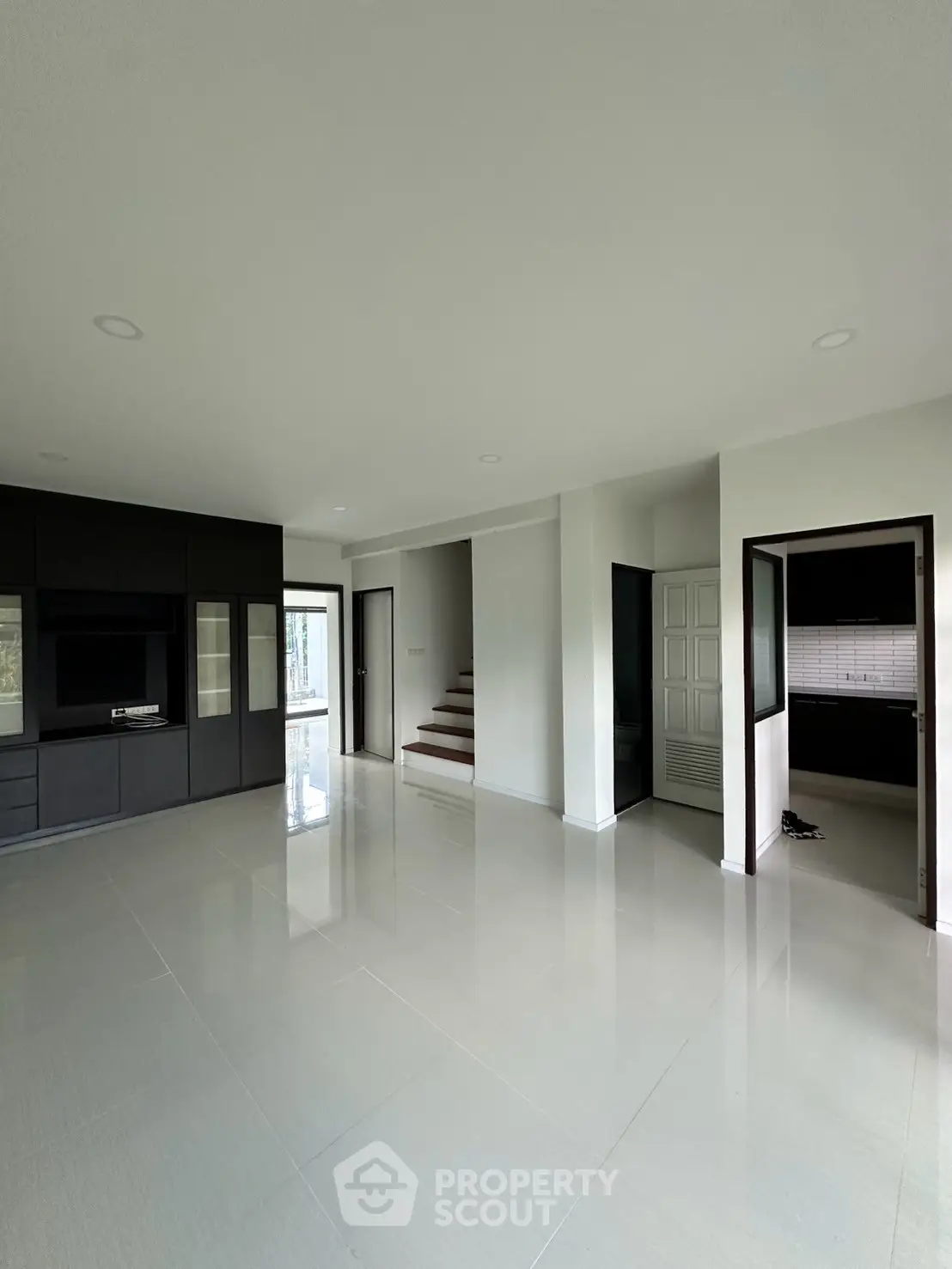 Spacious modern living room with sleek black cabinetry and open layout