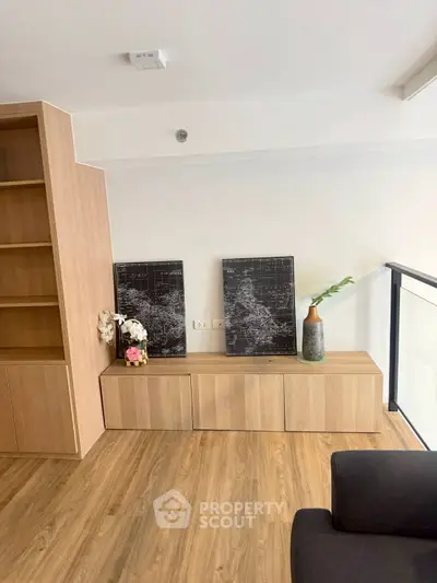 Modern living room with wooden flooring and stylish decor in a contemporary apartment.