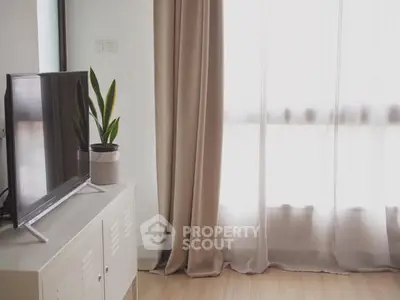 Modern living room with TV and elegant curtains