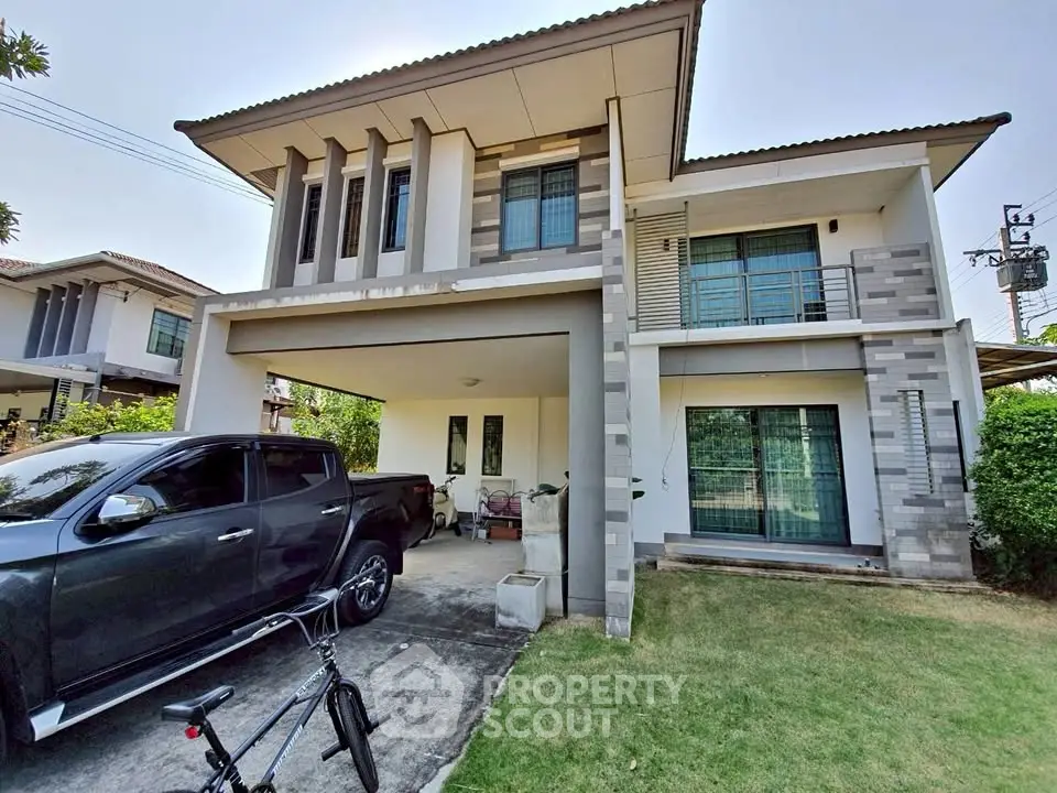 Modern two-story house with garage and garden in a suburban neighborhood.