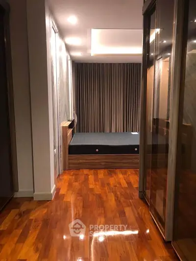 Luxurious bedroom with polished wooden floors and elegant drapery