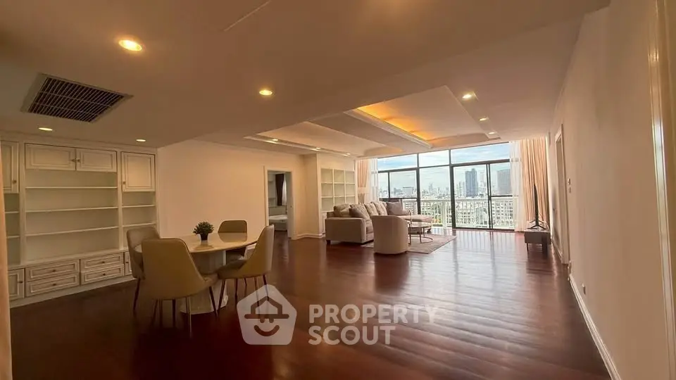 Spacious living room with city view and elegant dining area