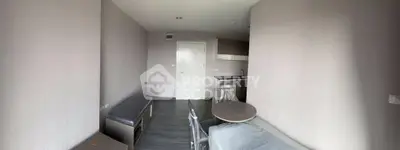 Modern minimalist studio apartment with sleek kitchen and cozy living area, perfect for urban living.