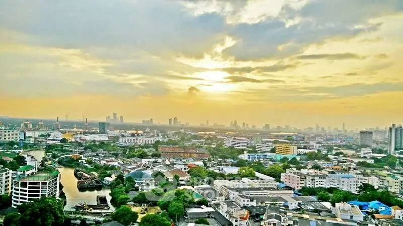 Stunning cityscape view at sunset with vibrant skyline and lush greenery.