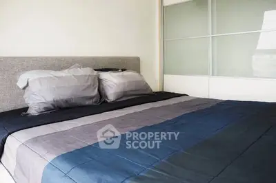 Modern bedroom with stylish bedding and sliding closet doors