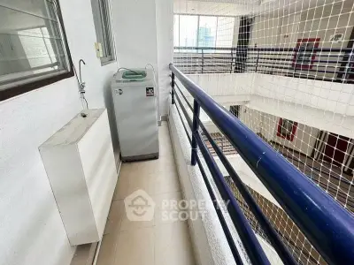 Spacious balcony with washing machine in modern apartment building
