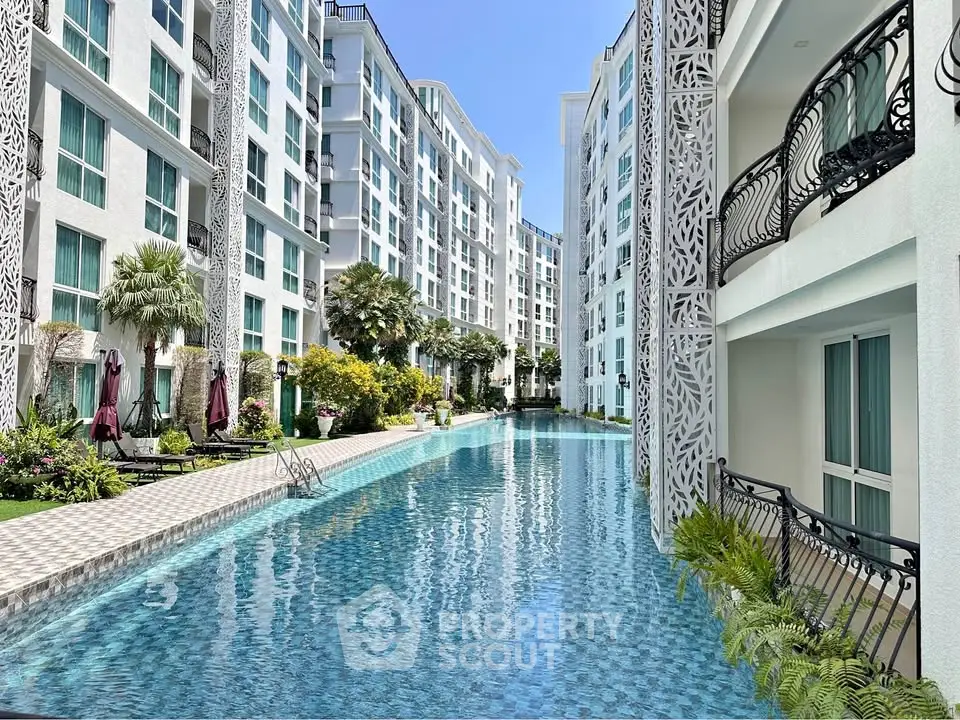 Luxurious residential complex with stunning pool and elegant architecture, perfect for modern living.