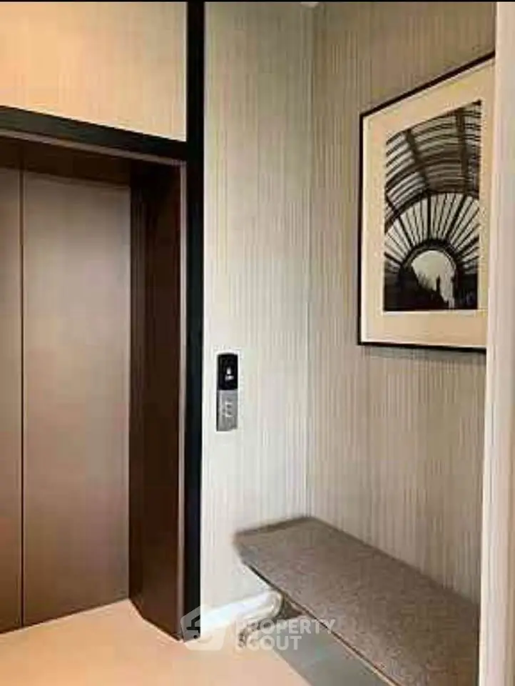 Modern elevator lobby with stylish decor and seating area.