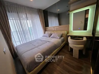 Modern bedroom with cozy bed, stylish mirror, and elegant decor in a high-rise apartment.