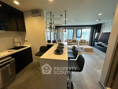 Modern open-plan kitchen and living room with sleek design and city view.