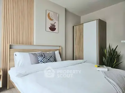 Modern bedroom with stylish decor and cozy bedding in a contemporary apartment.