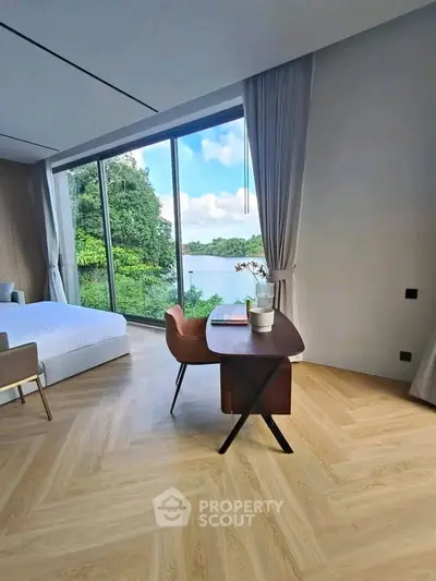 Luxurious bedroom with stunning lake view, featuring elegant wooden flooring and modern furnishings.