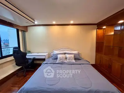 Spacious bedroom with city view, featuring a cozy bed and modern workspace.