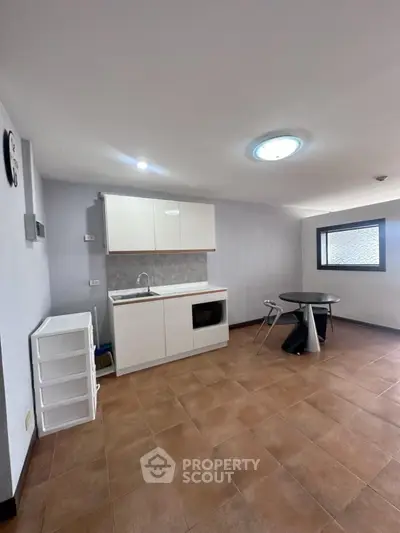 Compact modern kitchen with minimalist design and dining area