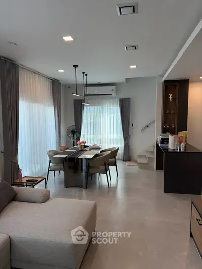 Modern living room with elegant dining area and stylish decor