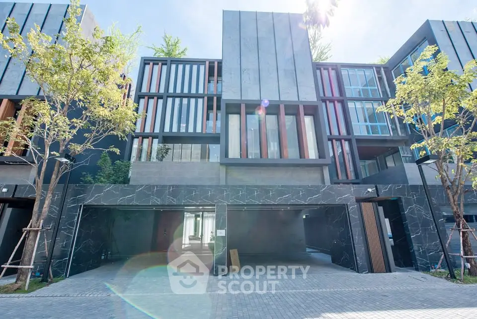 Modern luxury townhouse exterior with sleek design and spacious garage