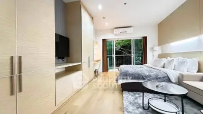Modern bedroom with balcony, stylish decor, and natural light in a contemporary apartment.