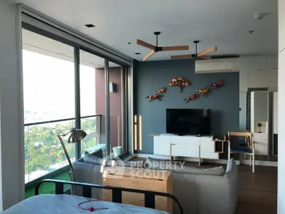Modern living room with stylish decor and expansive balcony view