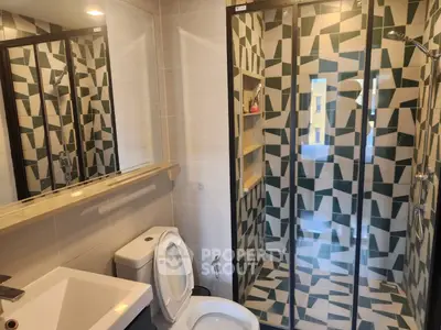 Modern bathroom with geometric tile shower and sleek fixtures