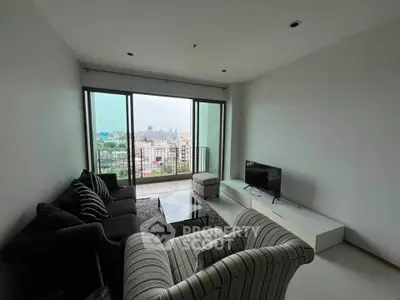 Spacious living room with panoramic city view and modern furnishings