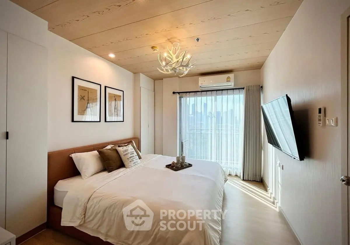 Modern bedroom with stylish decor and city view, featuring a cozy bed and wall-mounted TV.