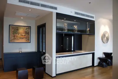 Modern living room with stylish decor and open layout, featuring elegant furniture and contemporary artwork.