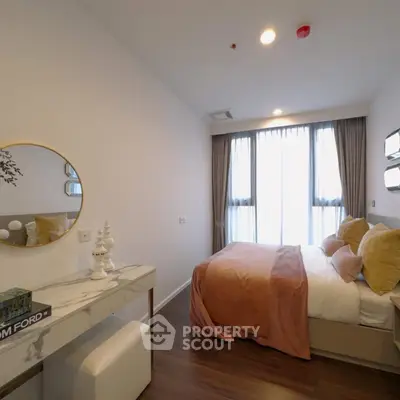 Elegant bedroom with modern decor and large window offering natural light