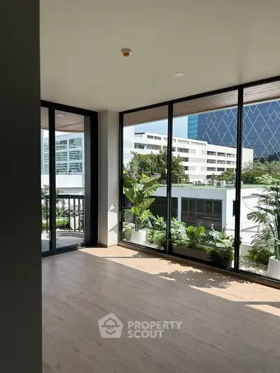 Spacious corner unit with floor-to-ceiling windows offering a stunning city view and abundant natural light.