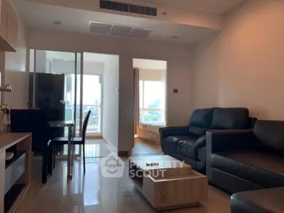 Modern living room with sleek furniture and city view, perfect for urban lifestyle seekers.