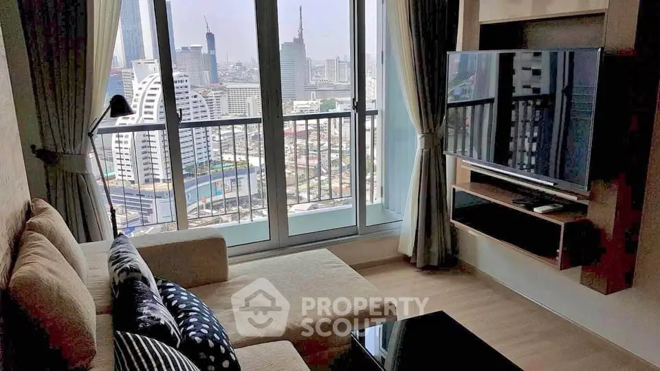 Modern living room with city view, featuring a cozy sofa and large TV, perfect for urban living.
