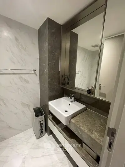 Modern bathroom with sleek marble finishes and stylish vanity