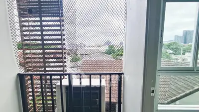 Modern balcony with city view and safety netting, ideal for urban living.
