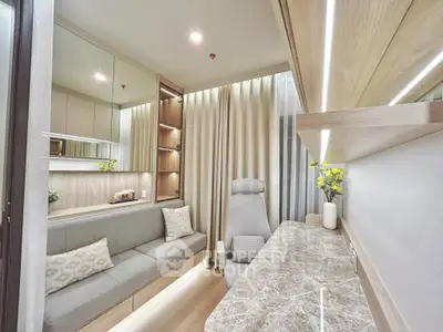 Modern study room with sleek design, marble desk, and cozy seating in a stylish apartment.