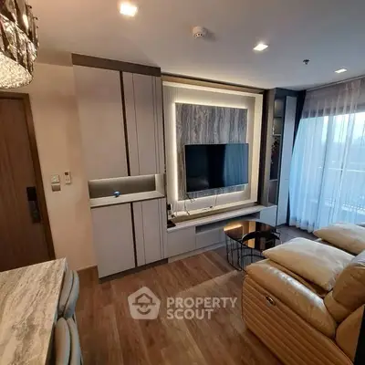 Modern living room with sleek TV setup and cozy leather seating