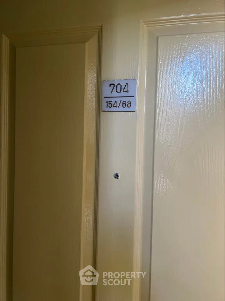 Apartment door with unit number 704 in a residential building.