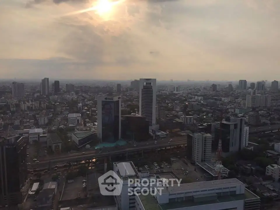 Stunning cityscape view from a high-rise building at sunset, showcasing urban skyline and architecture.