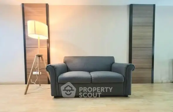 Modern living room with stylish sofa and floor lamp, perfect for relaxation.