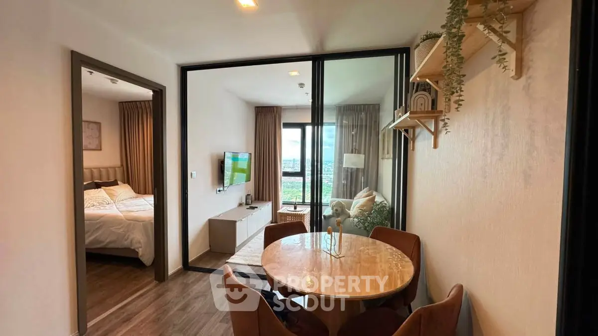 Modern apartment interior with cozy dining area and view into bedroom, featuring stylish decor and natural light.