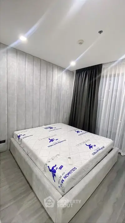 Modern bedroom with stylish decor and large bed in a contemporary apartment.