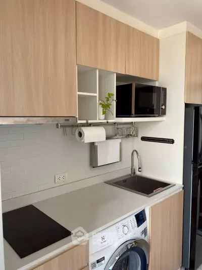 Modern kitchen with sleek cabinetry, integrated appliances, and efficient layout.