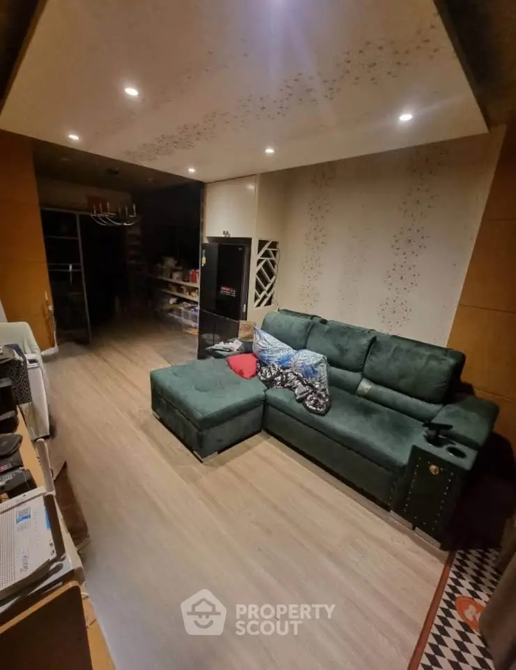 Cozy living room with green sectional sofa and modern decor