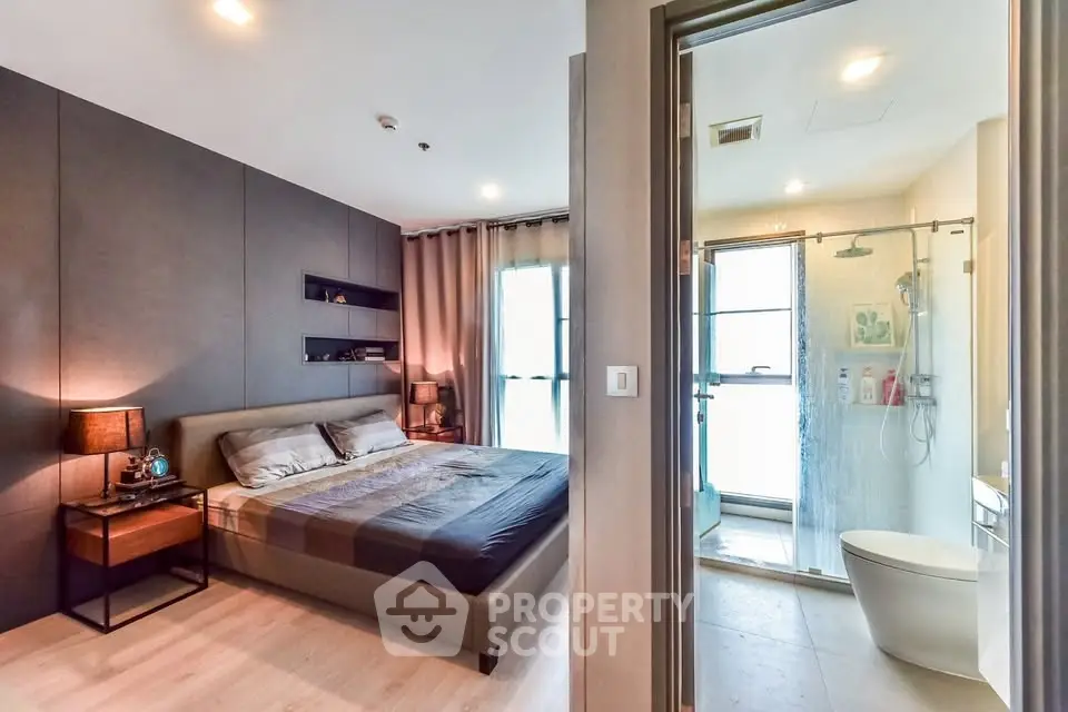 Modern bedroom with ensuite bathroom featuring sleek design and ambient lighting.