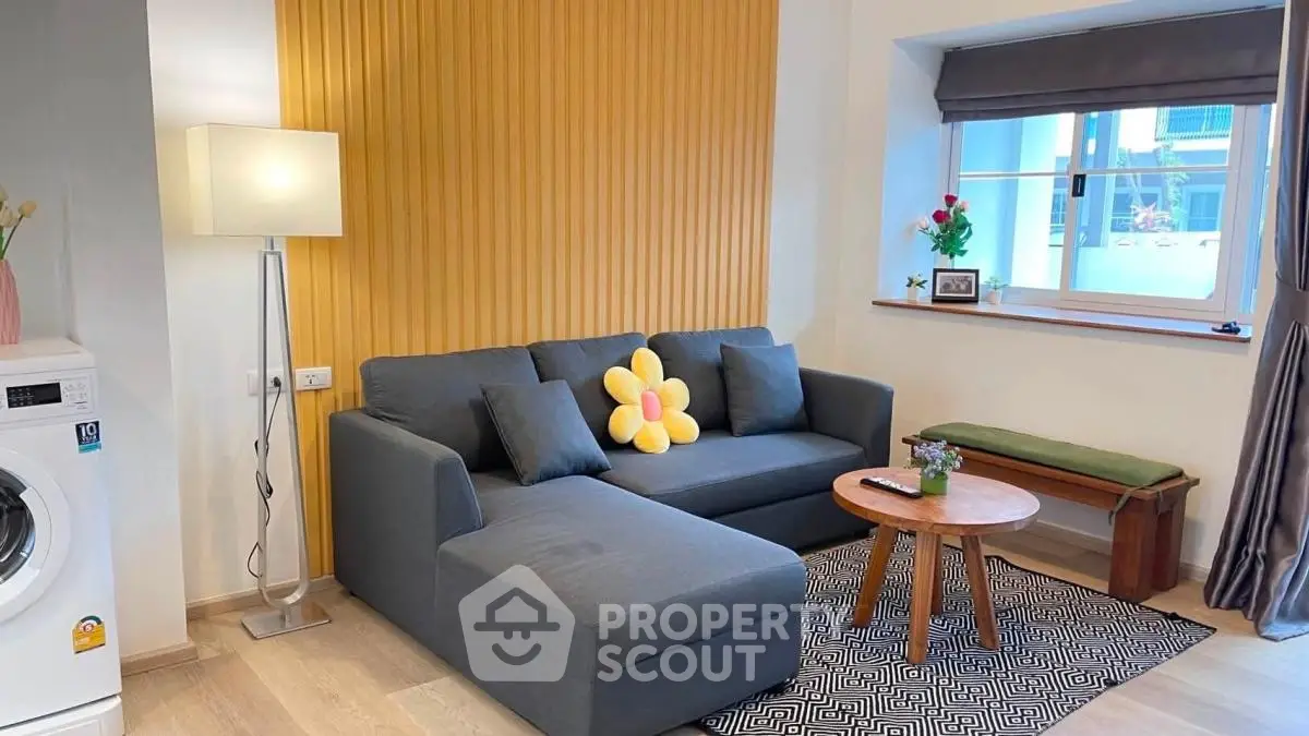 Charming living room with modern decor, cozy sofa, and natural light, perfect for relaxation.