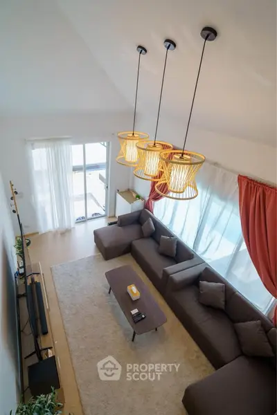 Spacious modern living room with stylish lighting and large windows